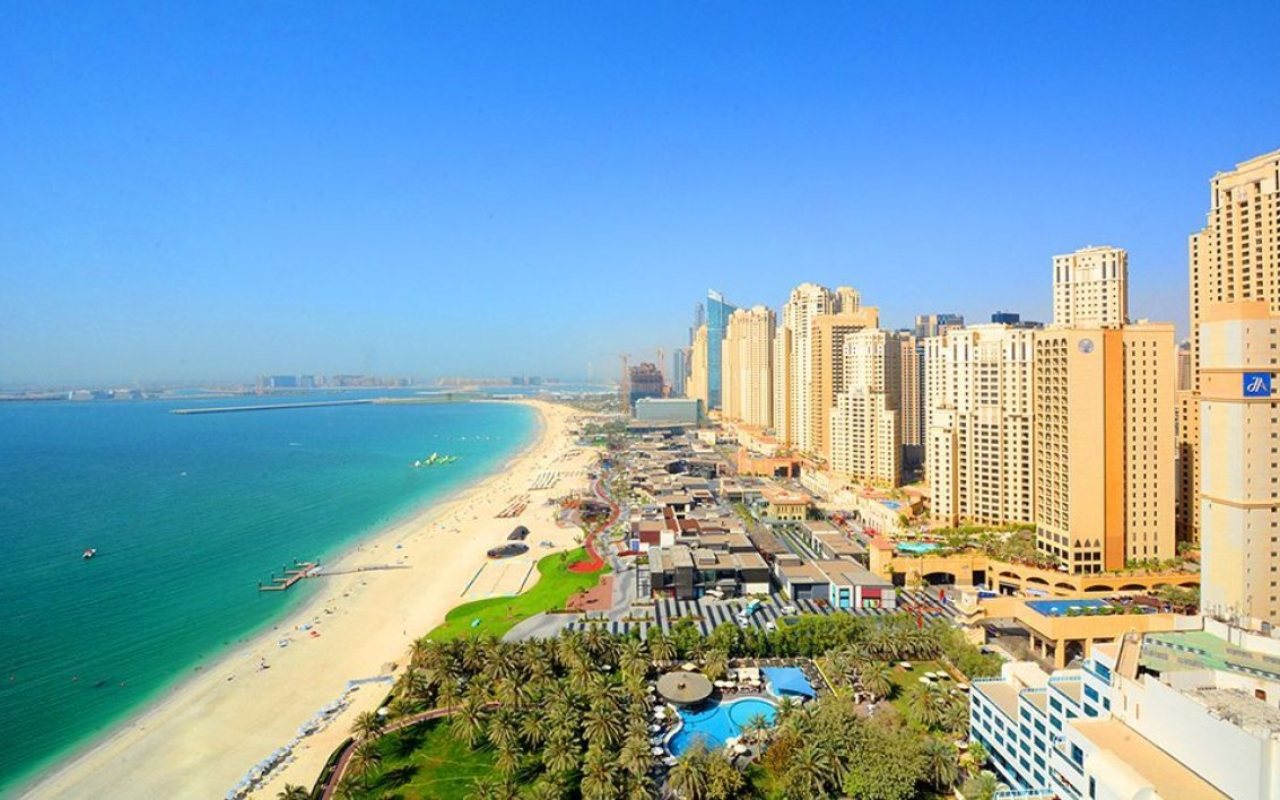 How can expats buy their own property in Dubai?